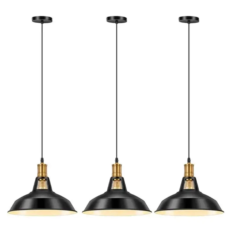 Three black and gold farmhouse industrial pendant lights hanging in a row, showcasing their design for kitchen island or dining room.