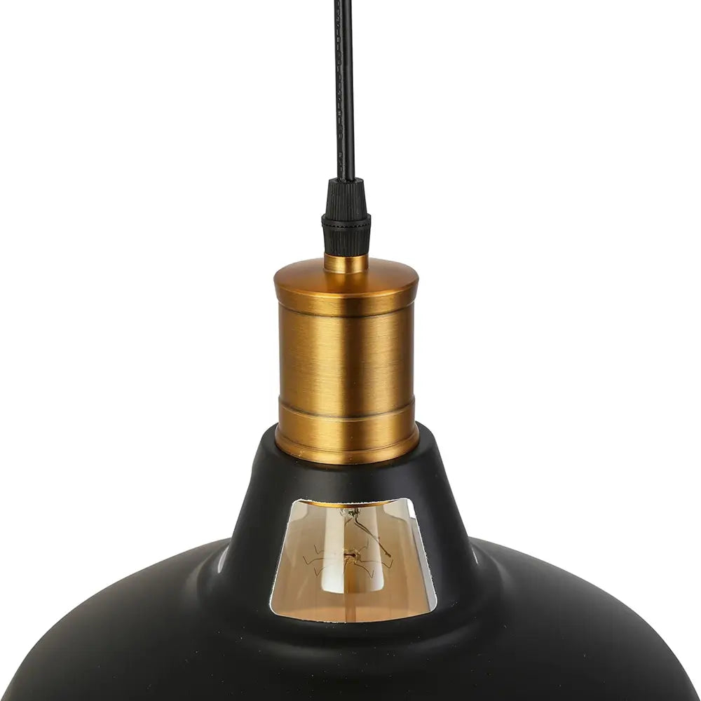 Detailed close-up of the textured brass light bulb socket and black cord connection point on the industrial pendant light.