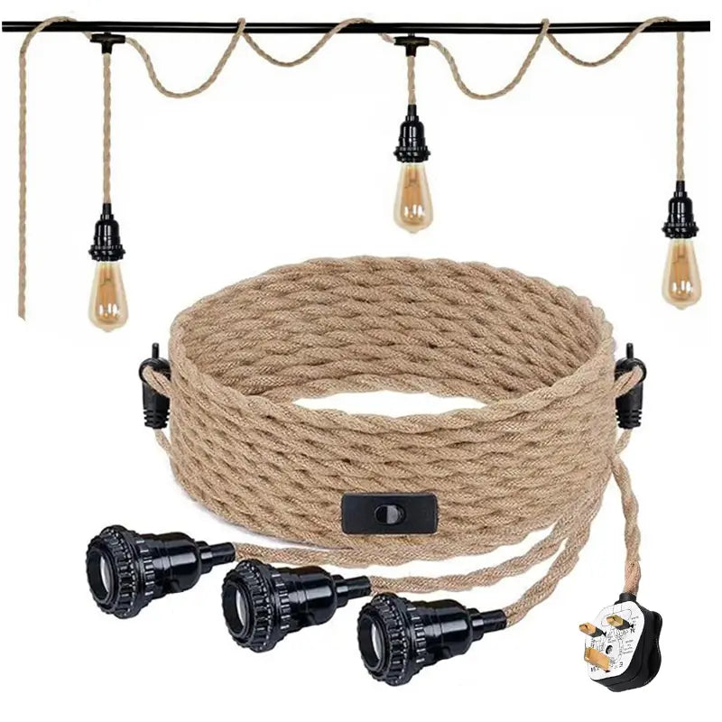 UK plug attached to a coiled brown rope cable with three black E27 lamp holders, an inline switch, and three vintage-style Edison light bulbs hanging from the same cable overhead.