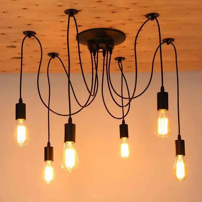 Adjustable hanging lighting mounted on a wooden ceiling, a black multi-pendant fixture with a mix of elongated and round Edison-style bulbs, showcasing its adaptability in terms of bulb style and cable arrangement.