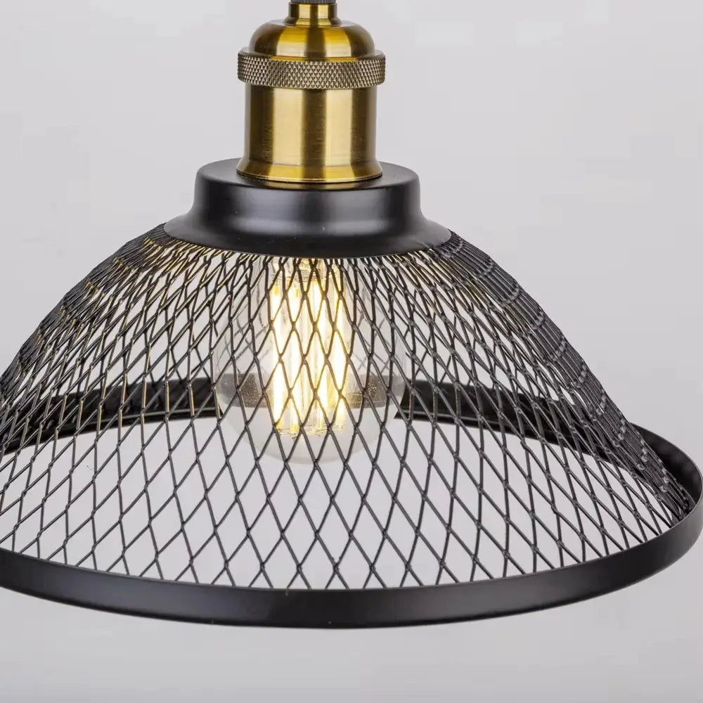 Close-up view of the adjustable height mechanism and brass fitting on a black industrial pendant light, showcasing the mesh metal shade and exposed Edison bulb.