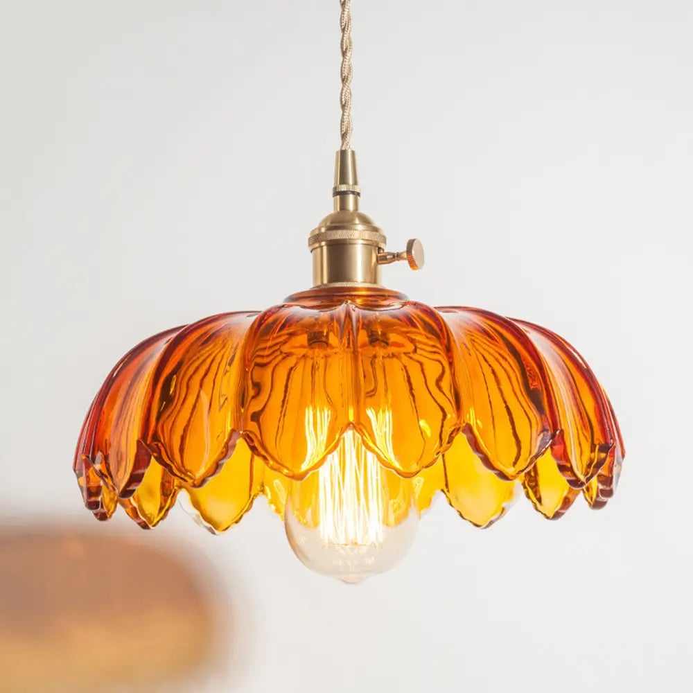 Close-up of amber pendant lighting with a fluted glass shade and a visible retro-style light bulb.