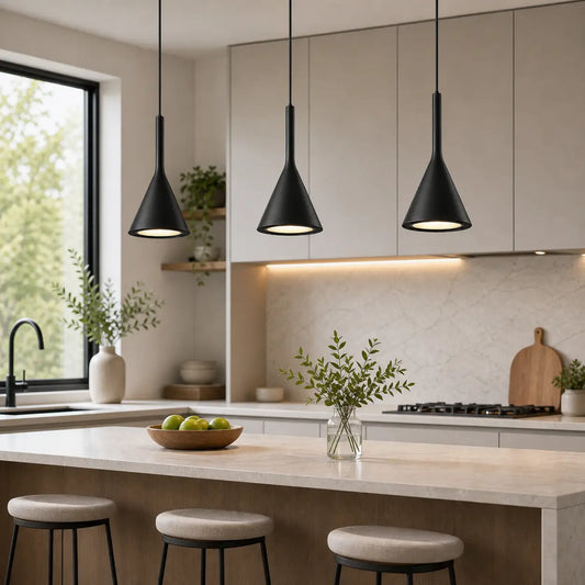 Three black cone pendant lights installed in a row above a light-toned kitchen island.