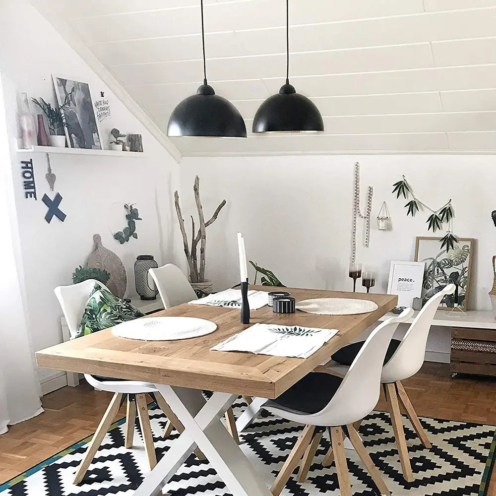 Black dome pendant lights installed over a wooden dining table, adding a contemporary and elegant touch to the dining room.