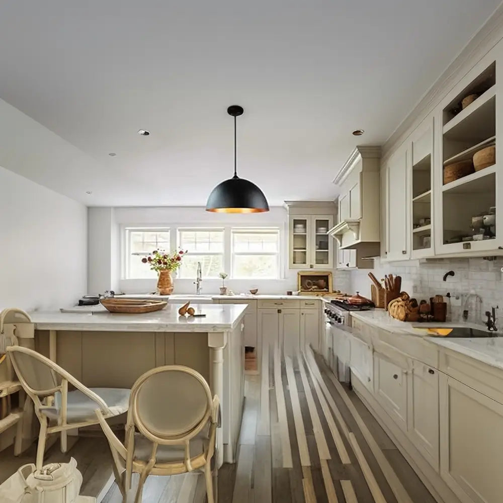 Modern kitchen featuring a black dome pendant light with a gold interior, adding elegance to the cooking space.