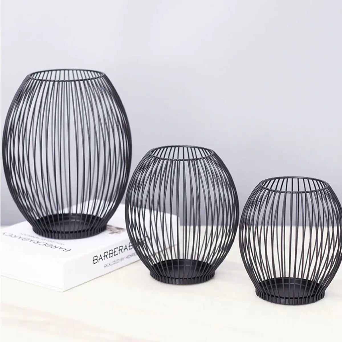 Black metal candle lanterns, a stylish set of 3 for contemporary home decor, weddings, and indoor ambiance lighting.