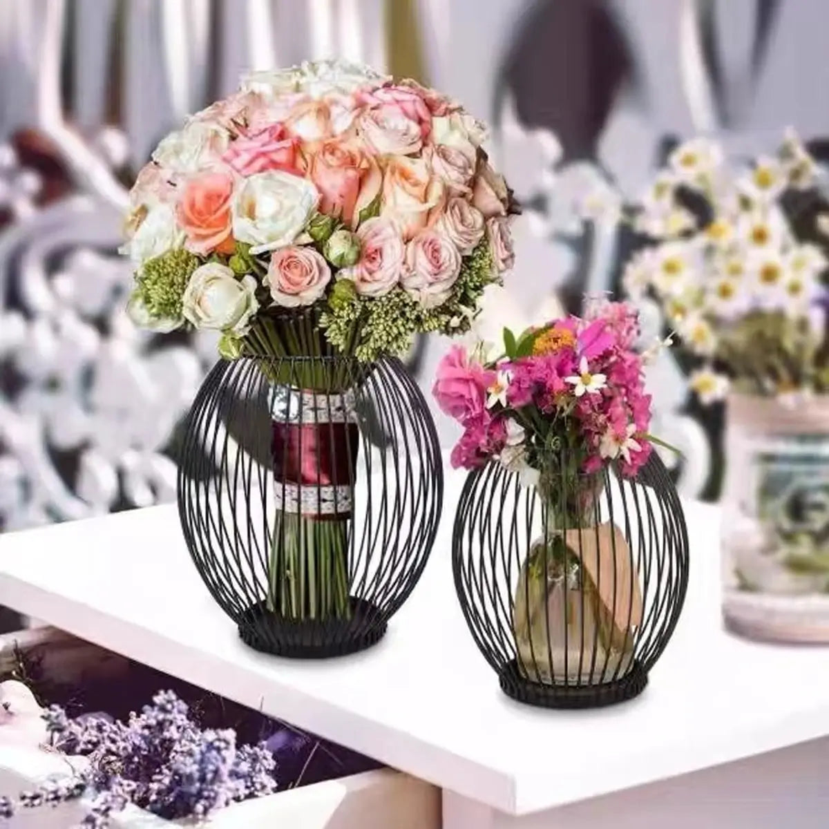 Black wire metal candle holder repurposed as a flower vase, creative home decoration idea for dining tables, weddings, and boho interiors.