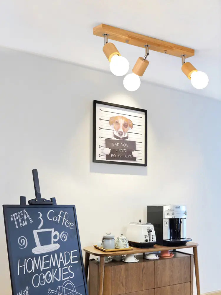 Wooden 3-light ceiling fixture installed above a cozy coffee station