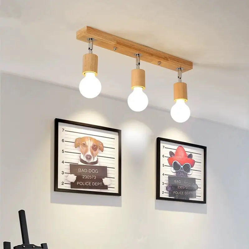 Modern 3-bulb ceiling light with wooden base installed in a living room setting.