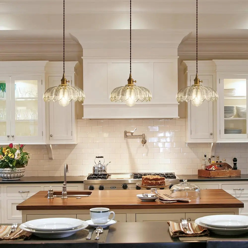 A clear fluted glass hanging lamp illuminates a dining table, adding a touch of retro charm to the dining room.