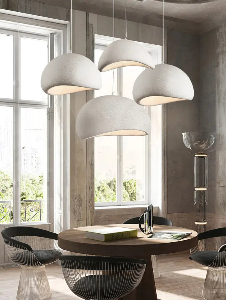 Set of four stone-textured pendant lights creating a bold focal point.
