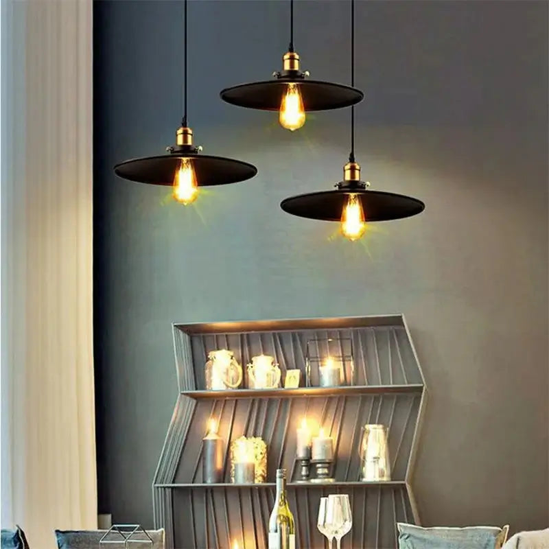 Three decorative black pendant lights with exposed Edison bulbs creating ambient lighting in a living room or dining area.