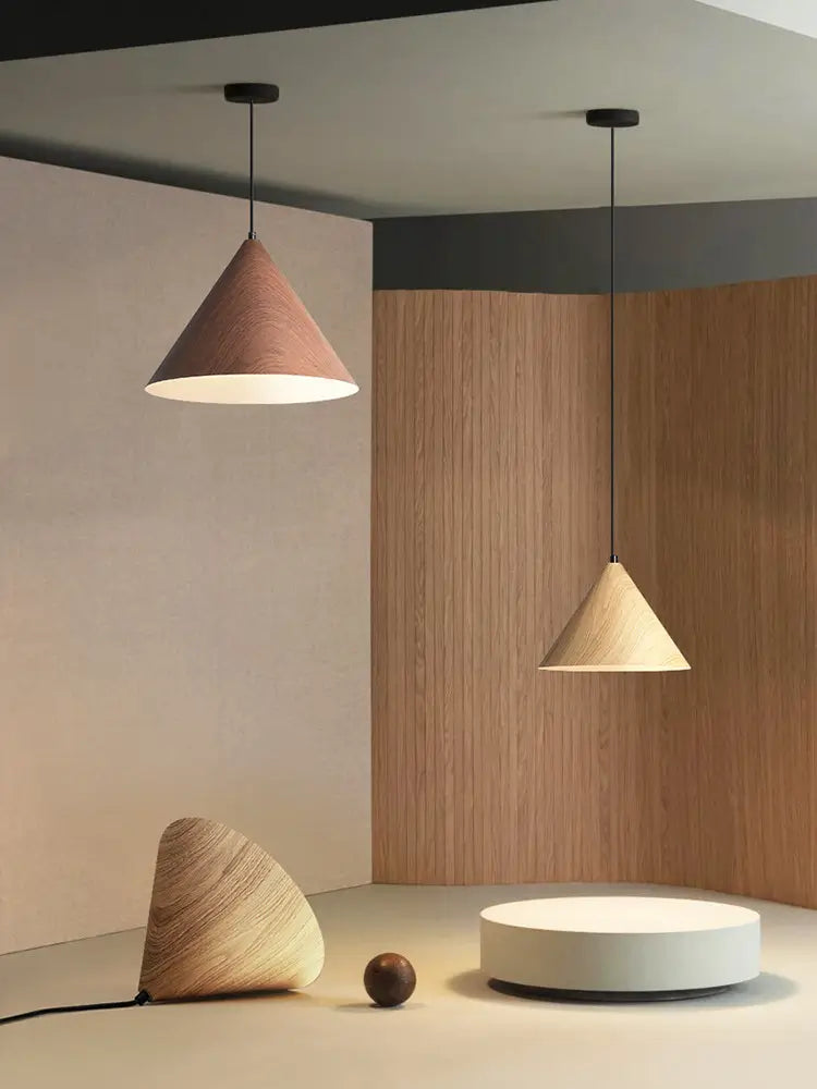Modern lighting display with iron pendant lamps in decorative wood grain finishes.