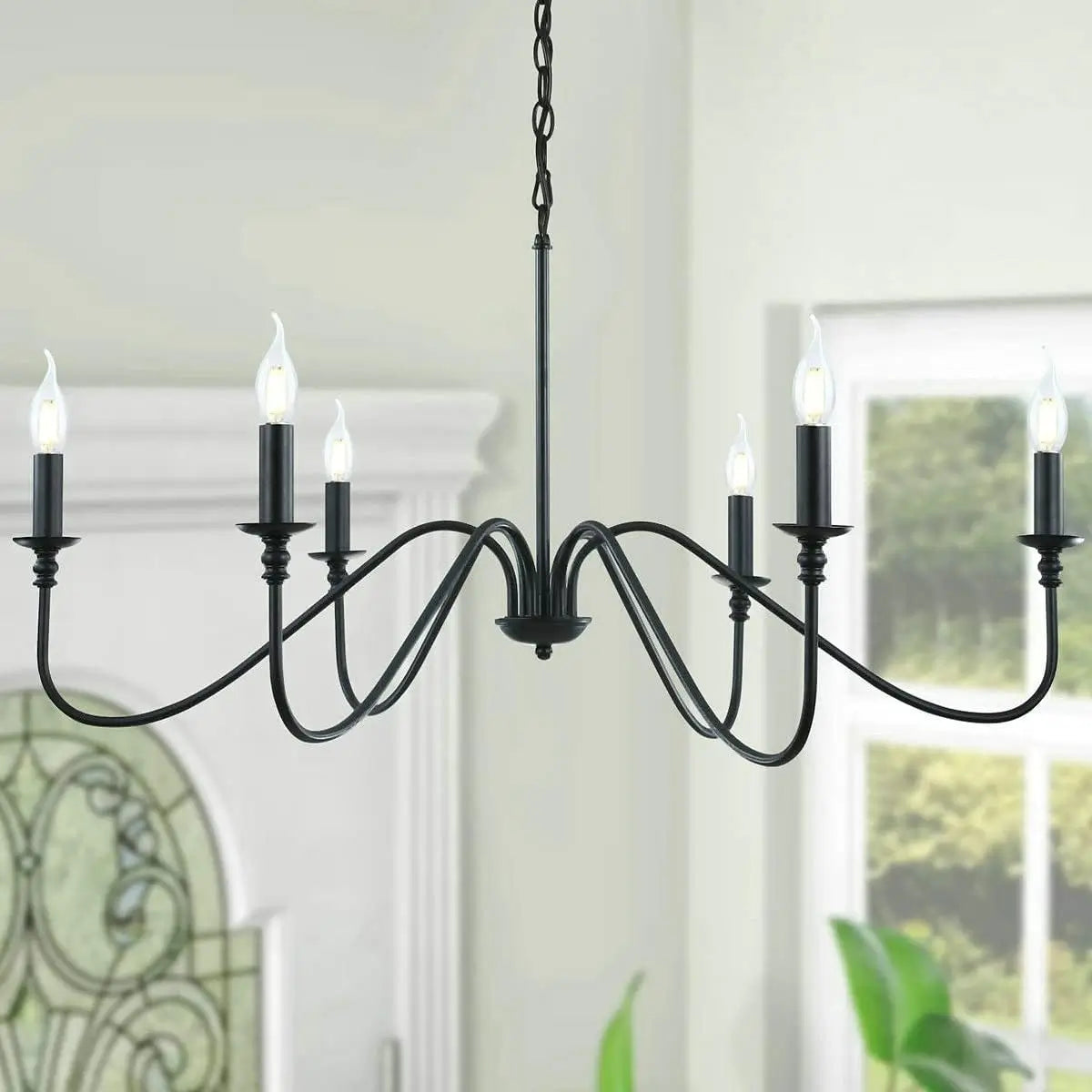 A black 6-light farmhouse style chandelier with a classic candelabra design.