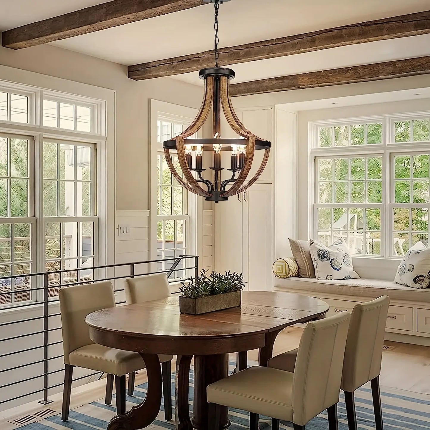 Farmhouse-style chandelier illuminating a kitchen island with rustic decor.