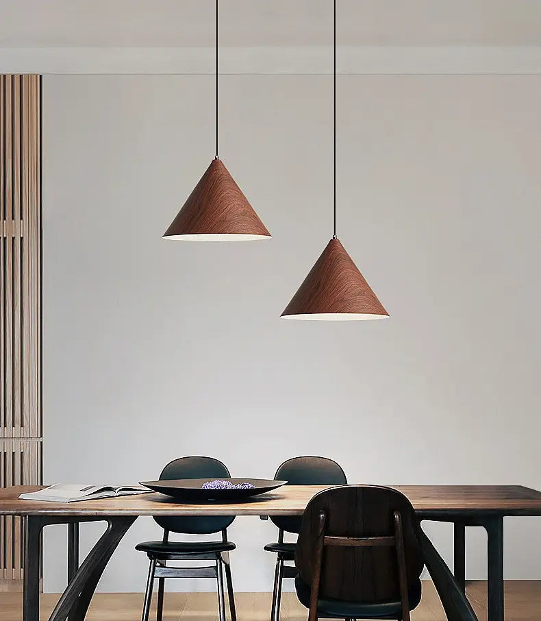 Dining room lighting with metal pendant lamps featuring wood-effect surface.