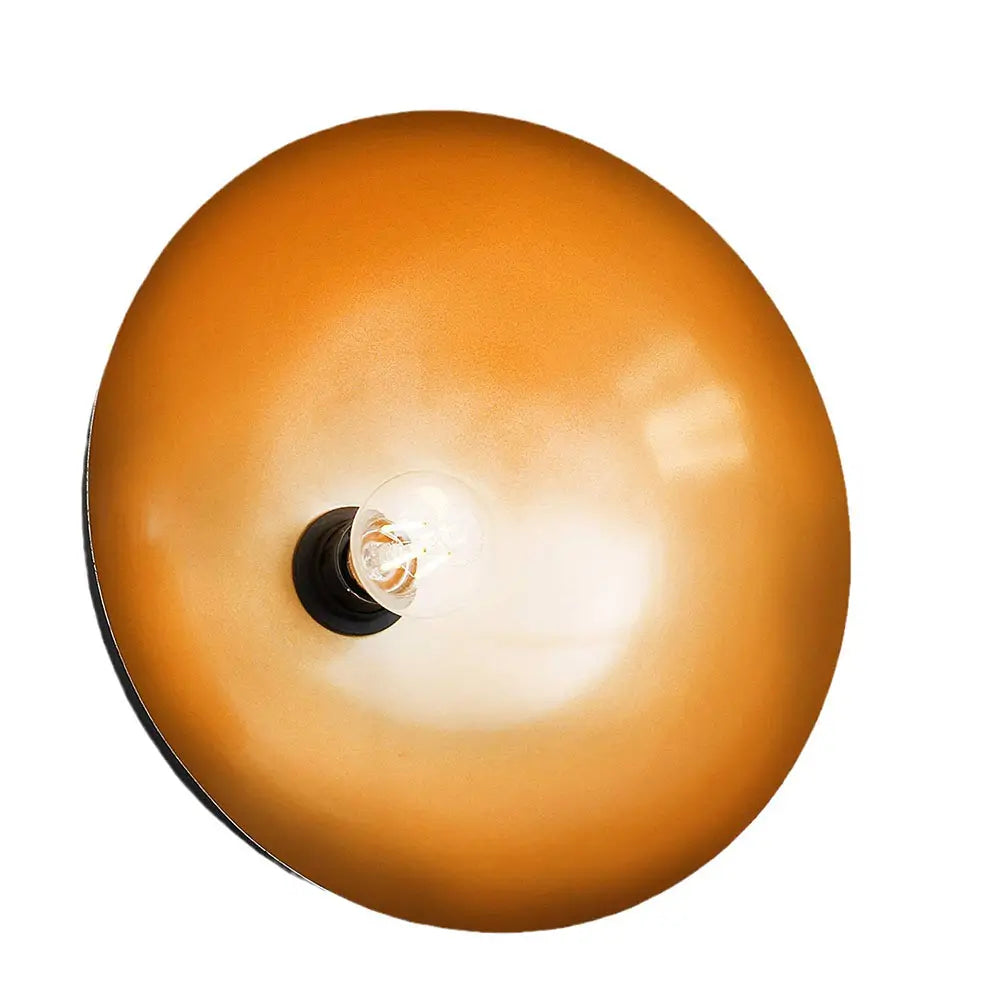 Close-up view of the gold interior of a black dome pendant light, highlighting its reflective and stylish design.