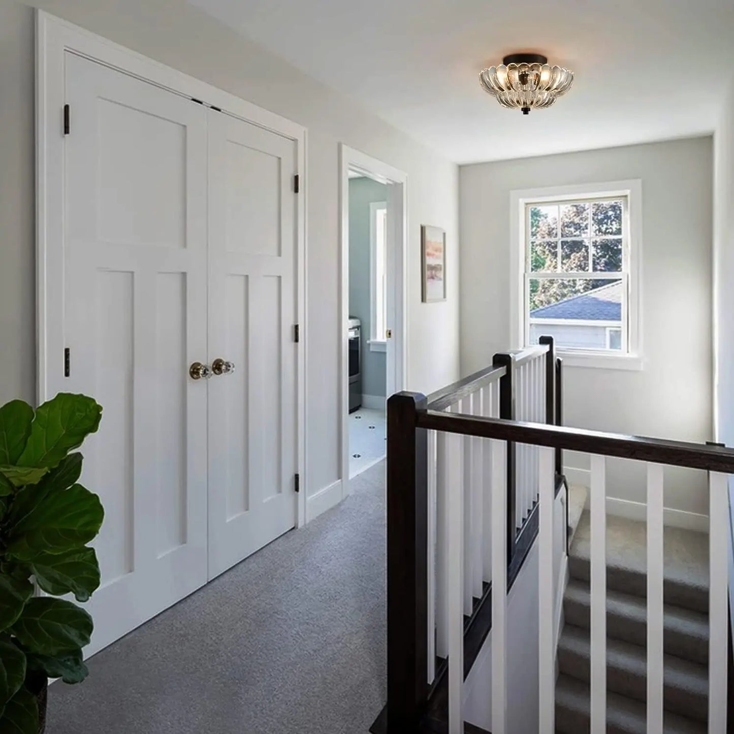 Amber glass flush mount light illuminating a bright hallway near staircase with natural light