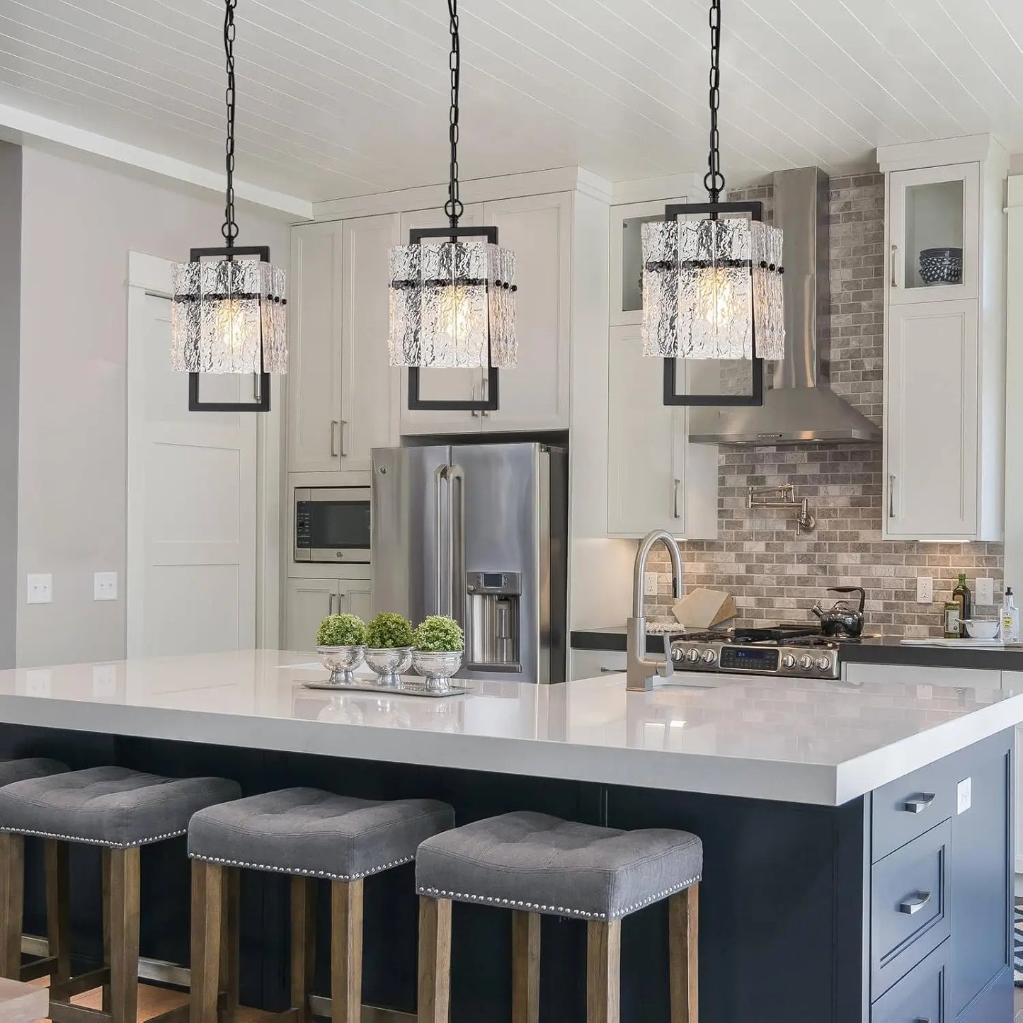 Industrial black pendant light with adjustable height for dining room lighting.