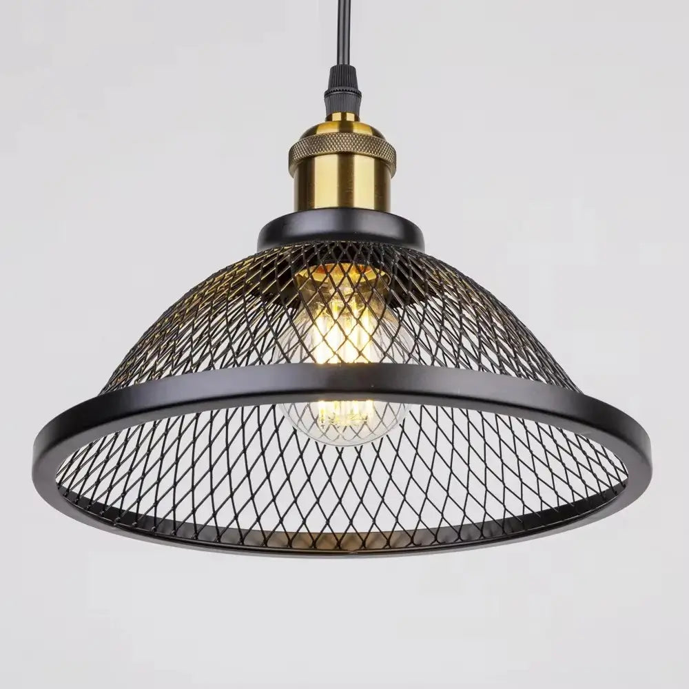 Close-up of a single industrial loft style hanging pendant light fixture featuring a black metal mesh shade and a brass-toned bulb holder, ideal for vintage or modern interiors.