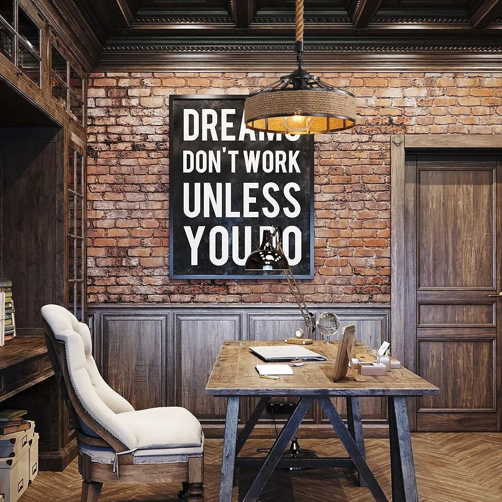 Industrial rope pendant light illuminating a stylish home office with rustic brick walls and wooden furniture.