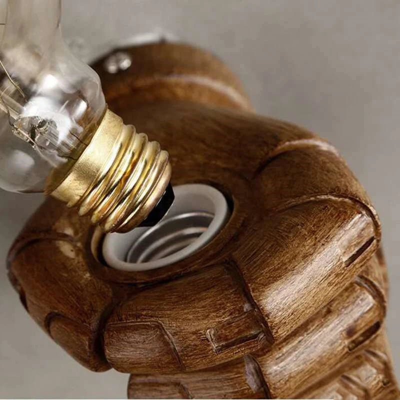 Industrial wall light fixture featuring a hand design, ideal for adding character to lofts, cafes, or gallery spaces.