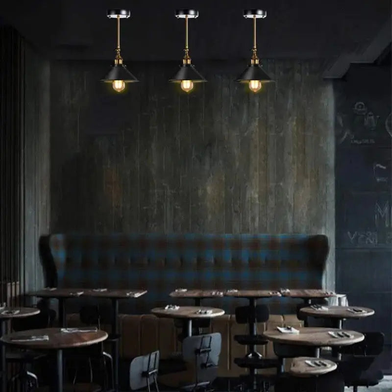 Black industrial wall sconce mounted on the ceiling, showcasing its versatility as a unique ceiling light fixture.