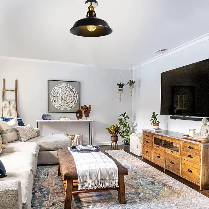 A modern living room featuring an industrial black metal ceiling light, blending with rustic and contemporary decor.