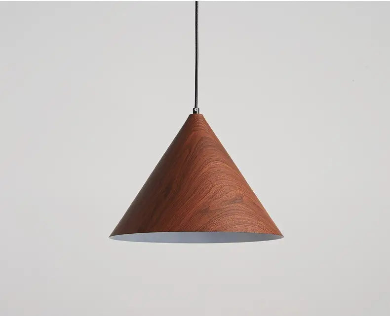 Close-up of iron cone pendant light with decorative wood grain texture.