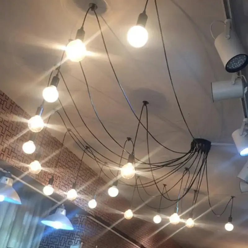 Minimalist black ceiling light, spider-style exposed bulb chandelier, industrial modern lighting for commercial spaces.