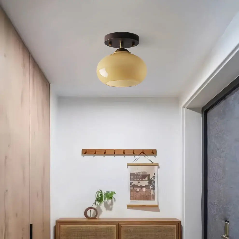 Minimalist walnut wood ceiling light fixture with an opal glass globe, perfect for contemporary spaces.