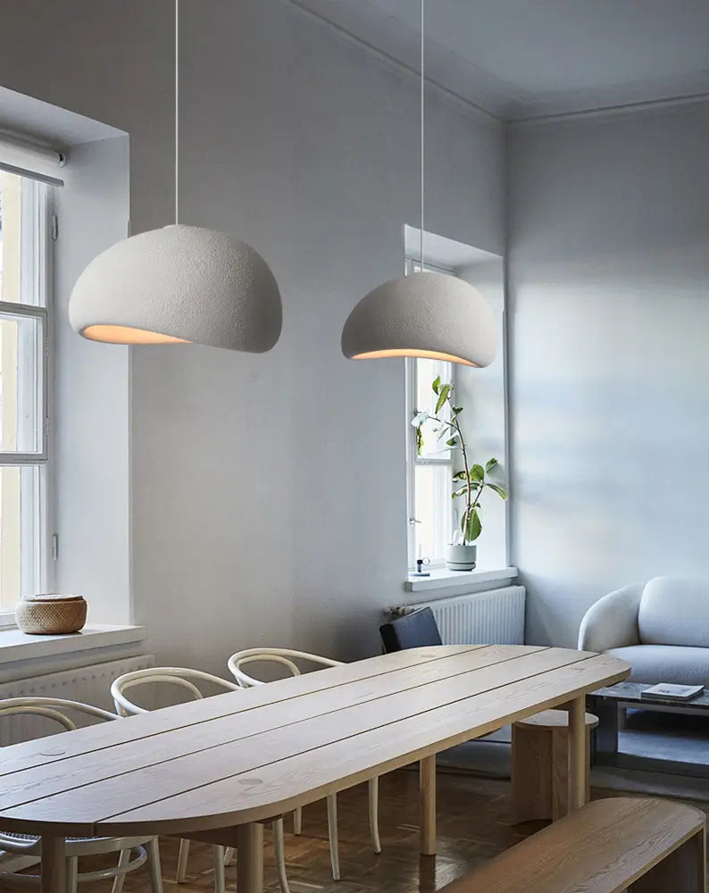 Contemporary pendant lamps in a bright dining and living area.