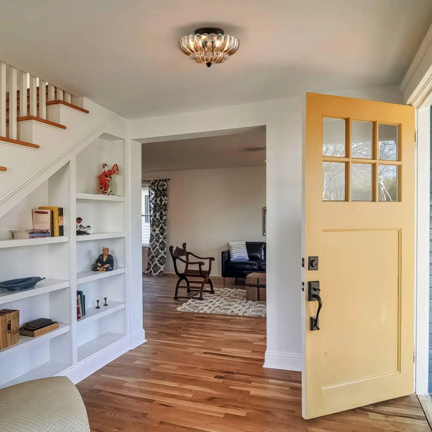 Amber glass flush mount light installed in a modern entryway with open front door and wooden flooring