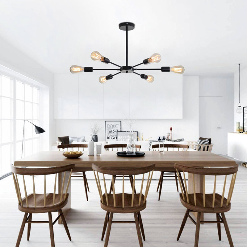 Modern industrial sputnik chandelier installed in a bright dining room with wooden furniture.