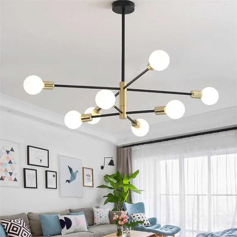 Modern minimalist sputnik chandelier with black and gold accents illuminating a stylish living room with contemporary decor.