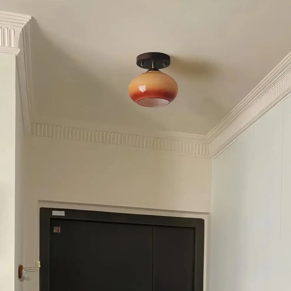 Detailed view of the ombre glass and walnut wood combination on a modern ceiling lamp.