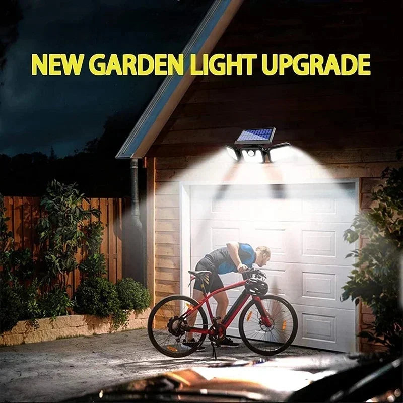 Solar security light installed above a garage, illuminating the driveway and person on a bike at night. Highlights enhanced safety and brightness for outdoor spaces like driveways and yards. New garden light upgrade.