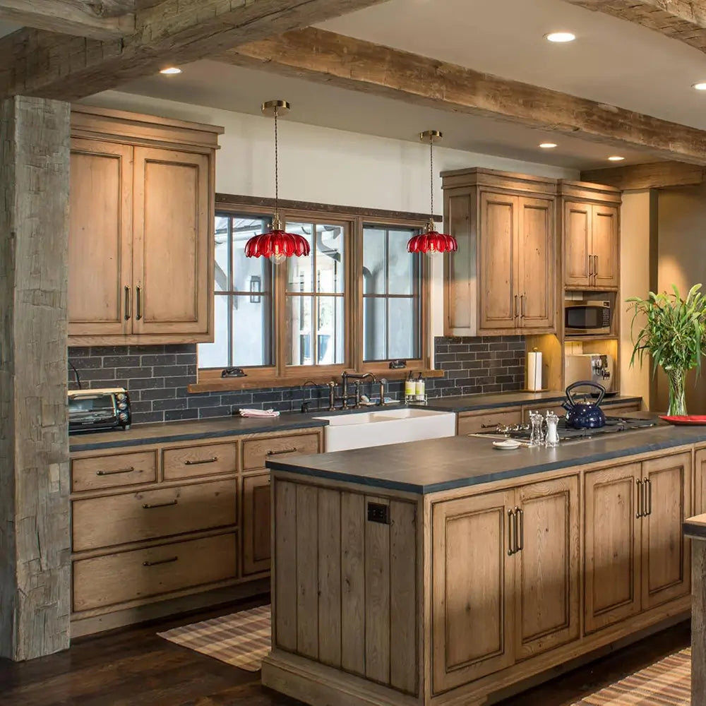 Two red glass pendant lights hanging above a kitchen island, providing focused and decorative kitchen island lighting.