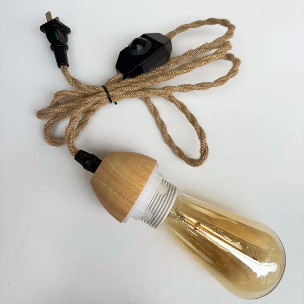 Close-up of rustic bamboo pendant light with Edison bulb and jute rope cord