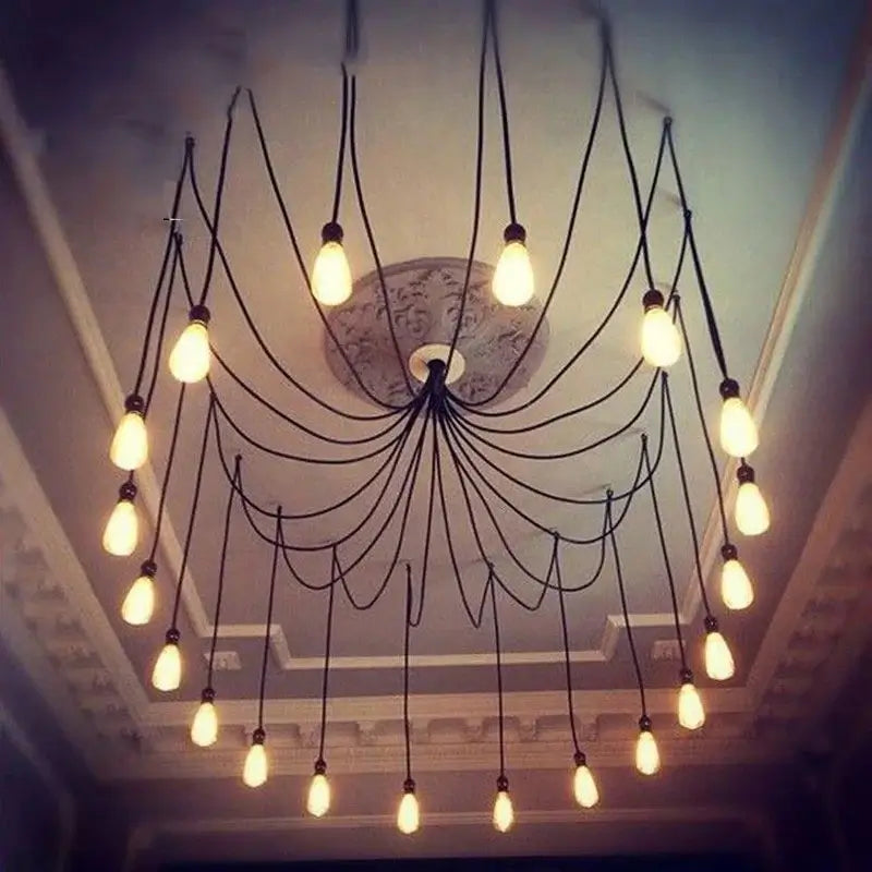 Vintage style ceiling lighting installed on a decorative ceiling, a spider chandelier with numerous exposed filament bulbs radiating from a central point, creating a classic aesthetic.