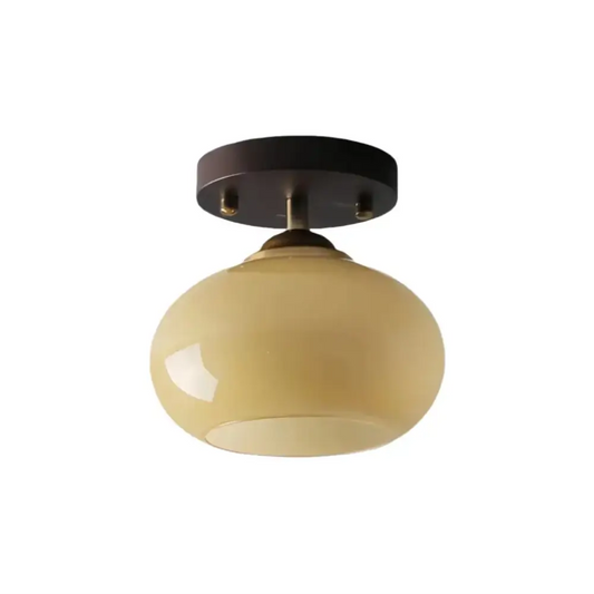 Minimalist cream opal glass semi-flush mount ceiling light with a rich walnut wood base isolated on a white background.