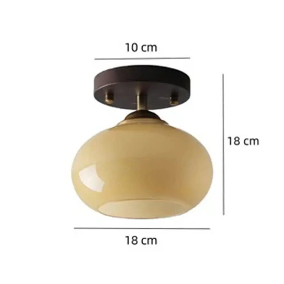Angled view of the walnut wood and glass ceiling light, showcasing its compact design and dimensions.