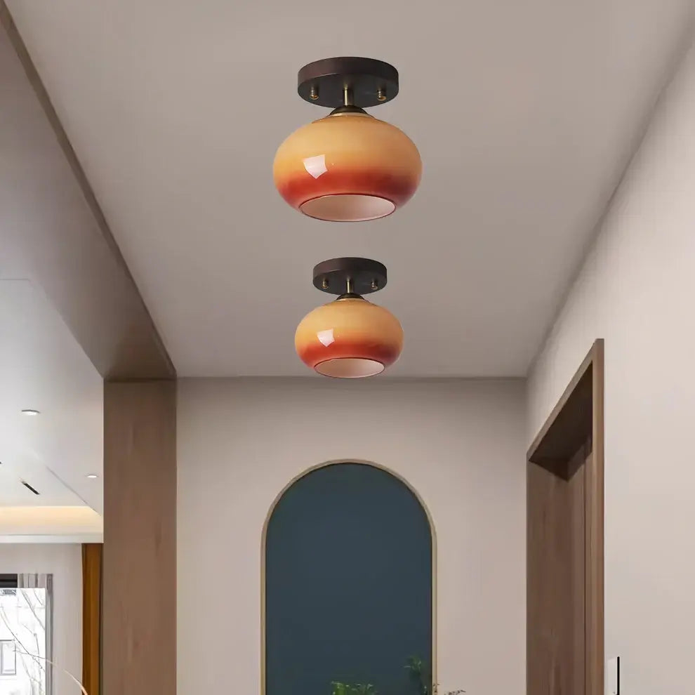 Walnut wood flush mount ceiling light illuminating a modern interior with warm, diffused light.