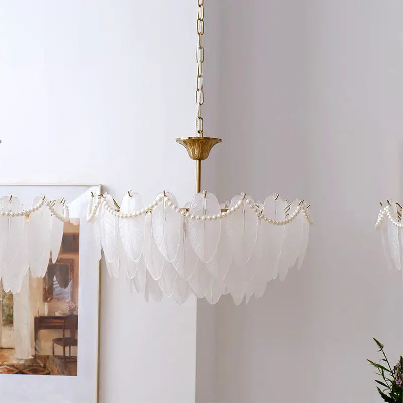 Stylish white feather-shaped glass chandelier with pearl details, perfect for contemporary and minimalist interior décor.