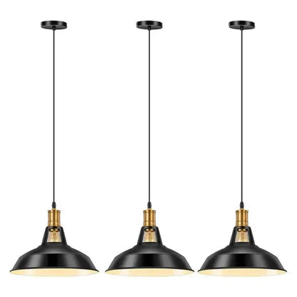 Three black and gold farmhouse industrial pendant lights hanging in a row, showcasing their design for kitchen island or dining room.