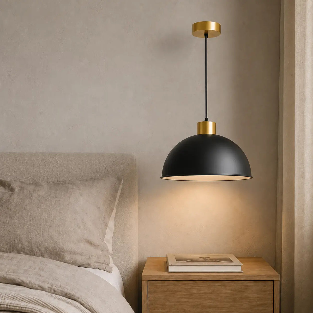 30 cm black dome pendant light installed beside a bed above a wood nightstand.