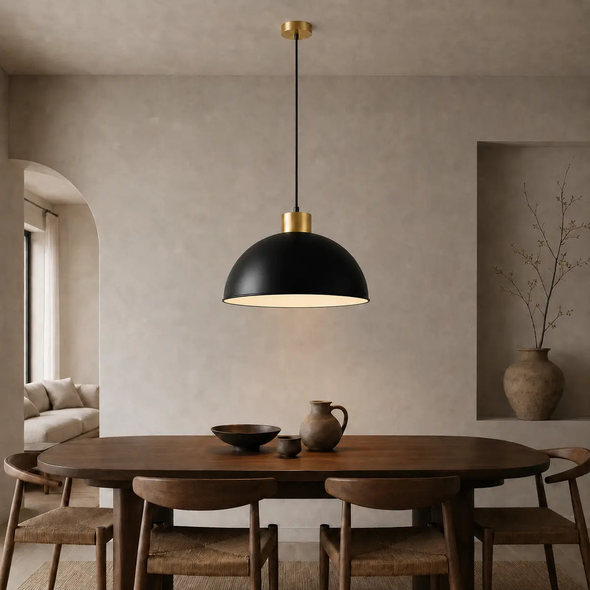 40 cm black dome pendant light installed above a wood dining table in a warm neutral dining room.
