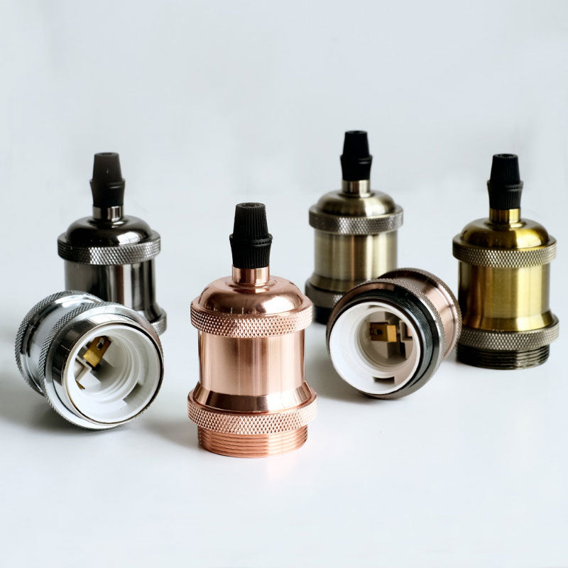 Collection of E27 metallic lamp sockets in copper, chrome, gold, and black finishes on display.