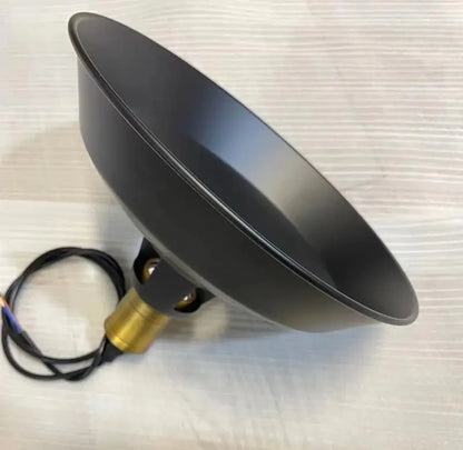 Underside view of the matte black metal dome shade and brass light fixture socket and wiring, showing quality construction.