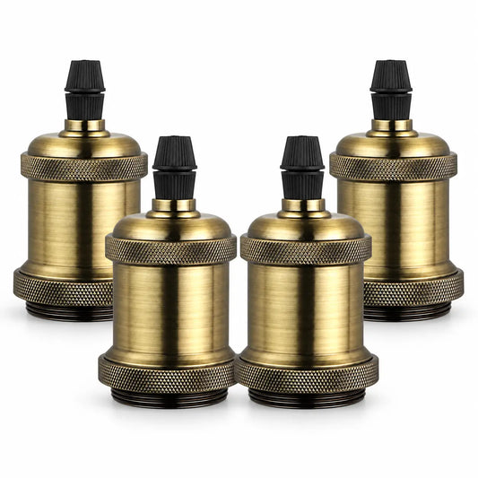 Four aged gold-toned vintage lamp sockets arranged in two rows, featuring textured grip rings and black ribbed top caps.